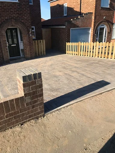 Block paving driveway with brick wall